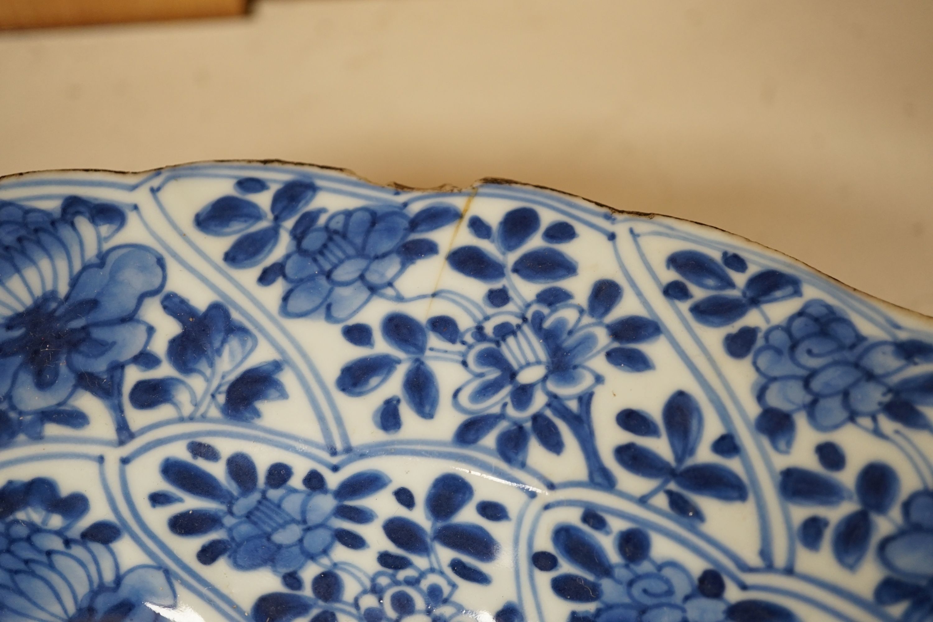 A pair of Chinese Kangxi blue and white dishes, painted with rock work and flowers, artemisia leaf marks, 37cm diameter